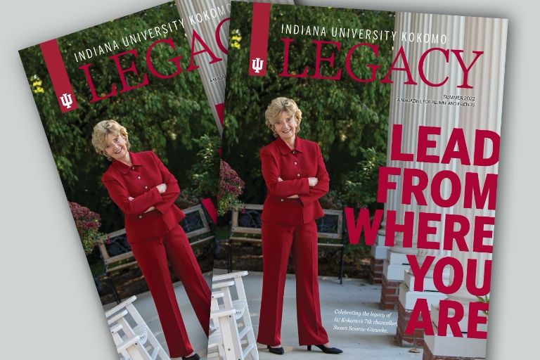 iuk chancellor wearing a red suit standing with her arms folded