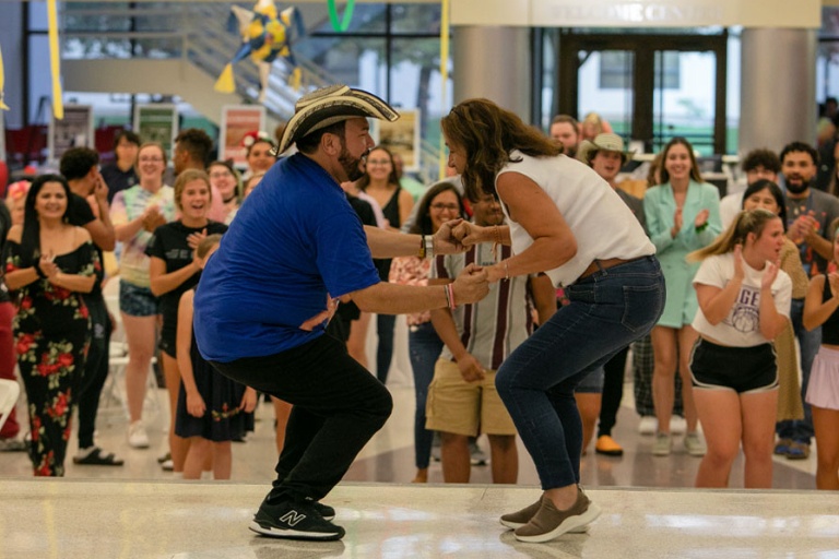 Two people dancing at Hispanic Heritage Month fiesta.