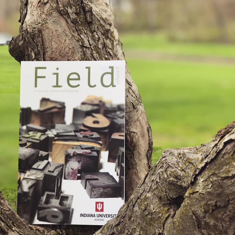 The field magazine up against a tree.