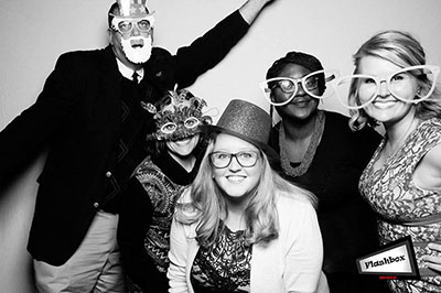 Group of faculty posing at event photobooth.