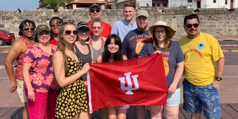 Students holding and IU flag.
