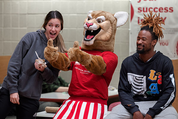 Kingston Cougar posing with students.